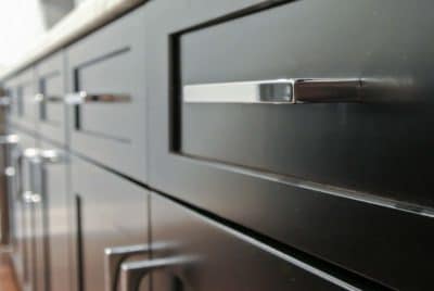 close up of modern dark colored cabinet and handles