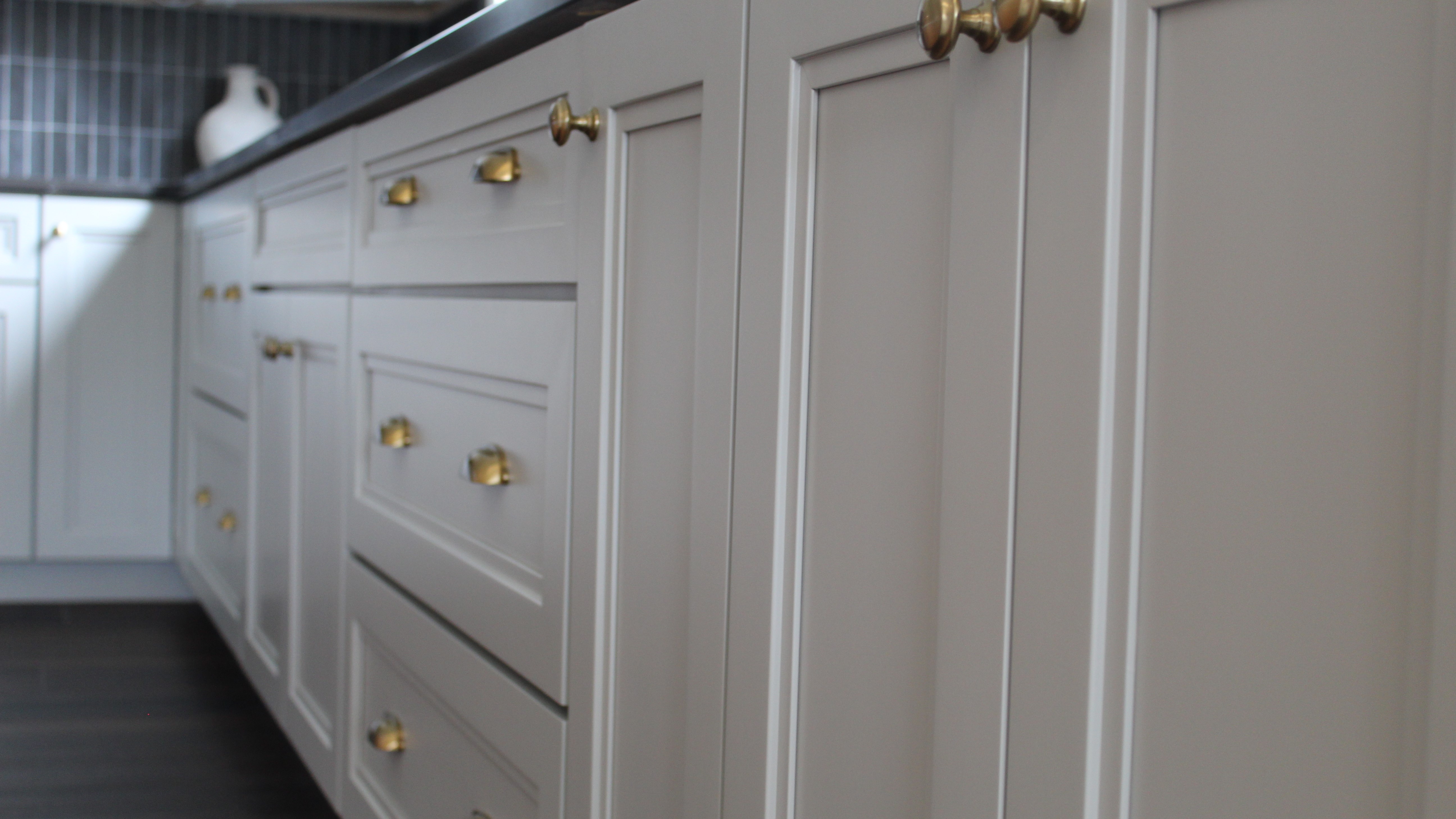 Close up of white cabinets with gold hardware